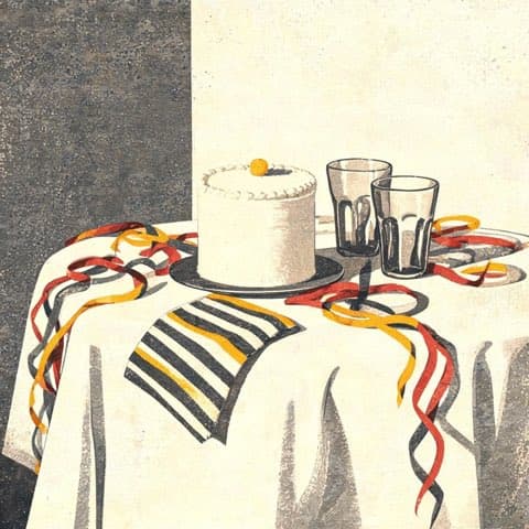 A birthday cake and ribbon decorations on a party table