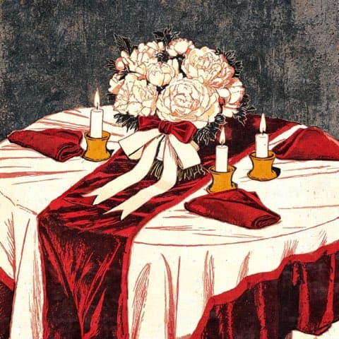 A wedding floral centerpiece with candles and ribbon