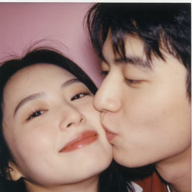 A couple laughing in a photo strip frame