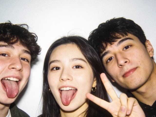 Four friends together, one sticking his tongue out