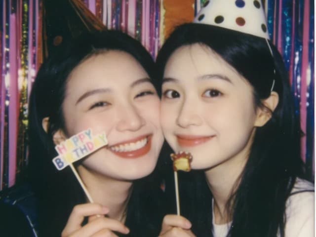 The same two friends mid-celebration