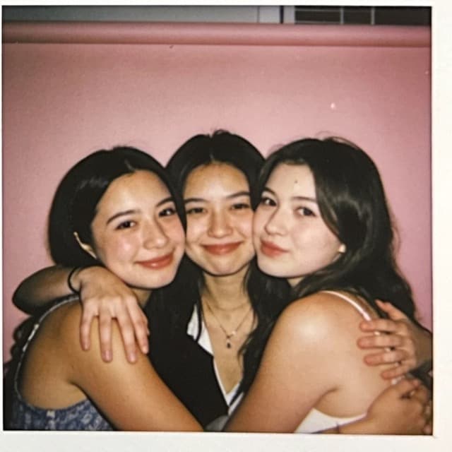 Friends crowded together and laughing in a photo booth frame