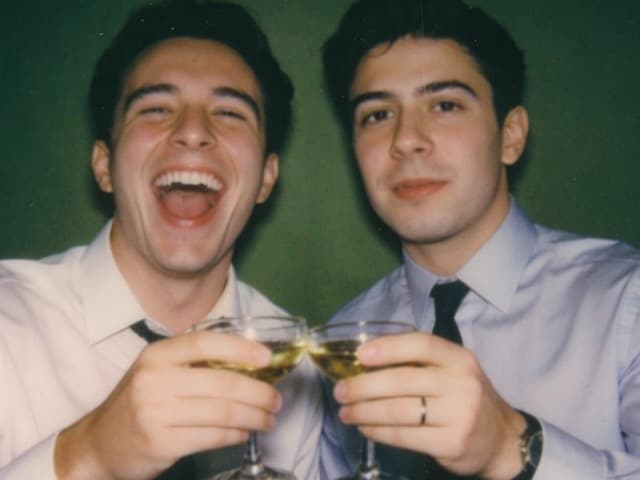 The same two friends smiling at the camera